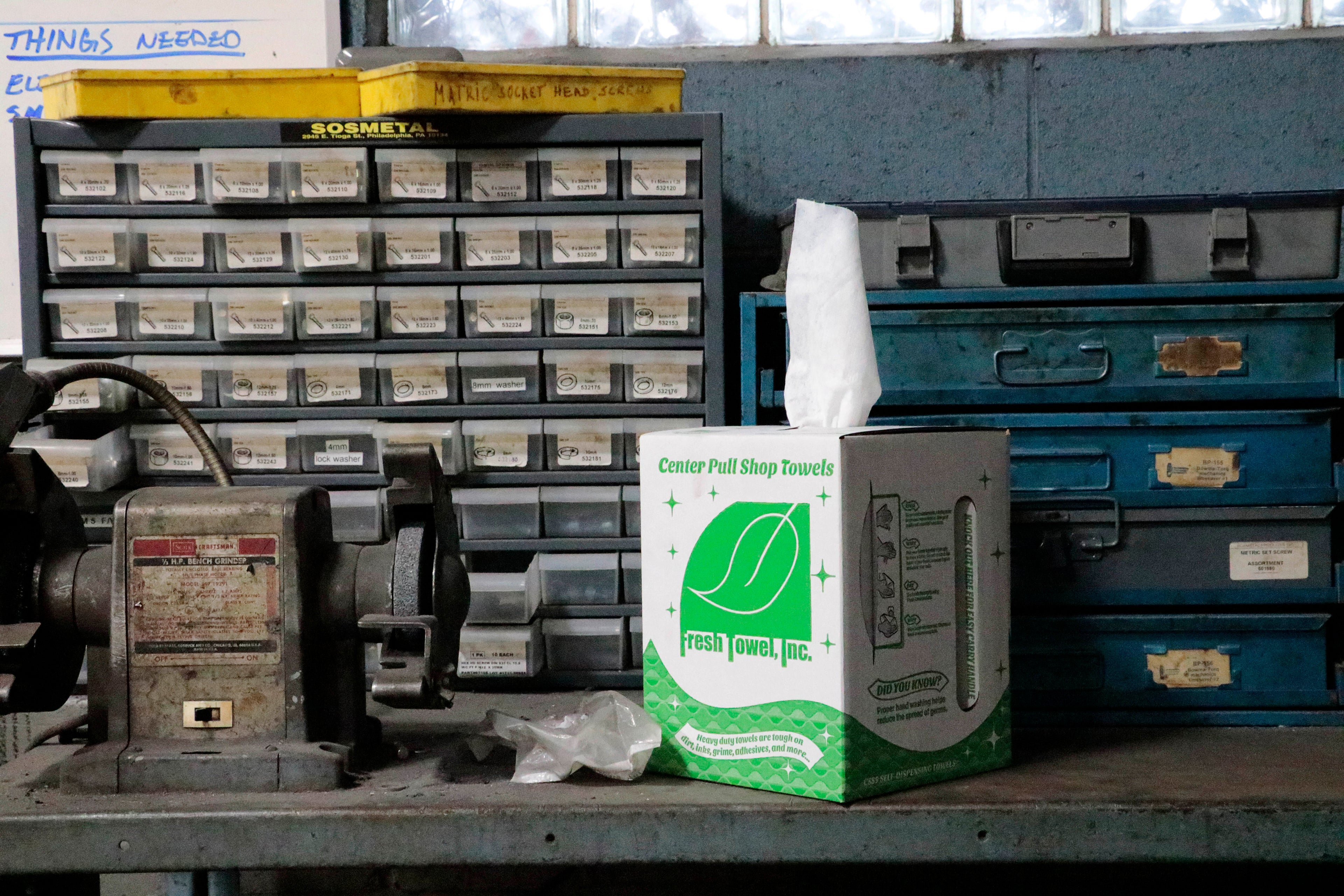 Box of Fresh Towel center pull shop towels in a mechanic shop with drawers in the background.